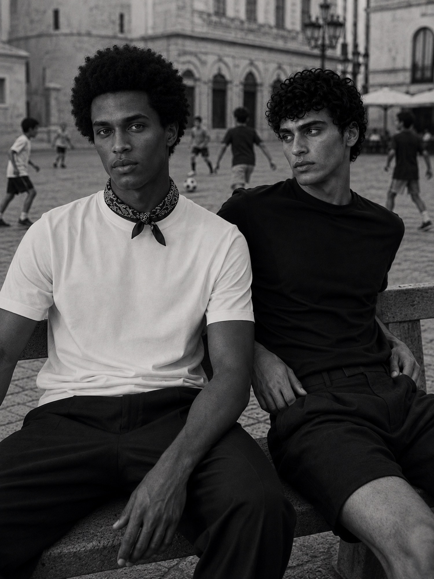 Two men in black and white on a city square